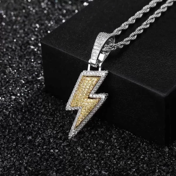 Bring the power of lightning to your style with this Iced Lightning Pendant in Yellow Gold. Featuring a sleek lightning bolt design encrusted with sparkling stones, this pendant is bold and eye-catching. The Yellow Gold plating ensures both durability and shine, while the waterproof, scratch-resistant, and hypoallergenic features make it perfect for everyday wear or special occasions. The iced-out stones add an electrifying touch, ensuring you stand out in any crowd. Ideal for anyone looking to express their bold Hip-Hop style with a striking piece of jewelry.