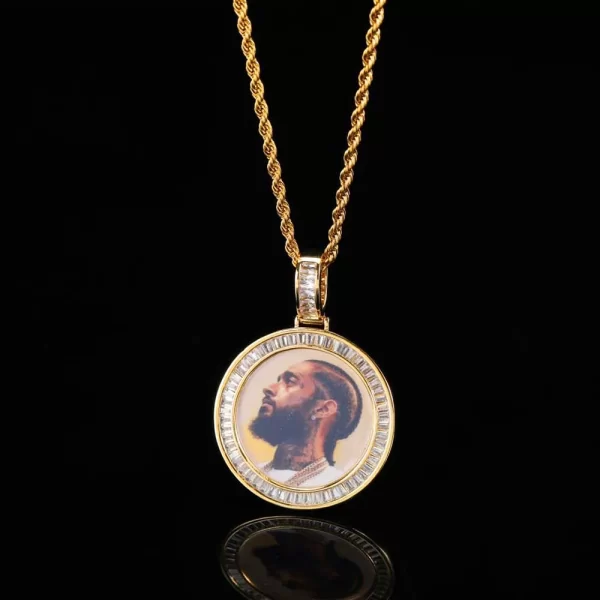 The Custom Baguette Picture Pendant in Yellow Gold is the perfect way to keep your most cherished memories close. At 40mm, it features a customizable picture area surrounded by baguette-cut stones for added glamour. The Yellow Gold-plated finish ensures durability while the hypoallergenic, waterproof, and scratch-resistant properties make it ideal for everyday wear. Whether it’s a personal keepsake or a thoughtful gift, this pendant allows you to add a luxurious and sentimental touch to any outfit.