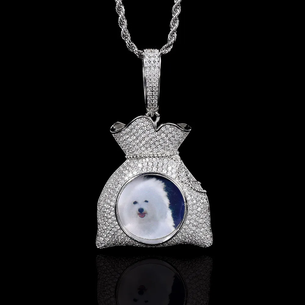 The Custom Money Bag Picture Pendant in White Gold takes personalized jewelry to a new level. With a sleek, polished finish, this pendant showcases a custom photo surrounded by sparkling stones. Hypoallergenic and waterproof, it’s built for daily wear, adding a touch of luxury to any outfit. Whether as a gift or for yourself, this pendant captures wealth and personal style with a Hip Hop twist.