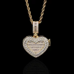 Show your love in a unique way with the Custom Iced Flip Cover Heart Pendant in Yellow Gold. This 31mm heart-shaped pendant is adorned with shimmering VVS simulated diamonds, adding a luxurious sparkle to your jewelry collection. The flip cover design lets you reveal a hidden photo or message inside, making it the perfect personal keepsake. The Yellow Gold plating ensures it stands out, while the hypoallergenic and waterproof features guarantee lasting durability and comfort. Whether you're gifting it to someone special or wearing it yourself, this piece is a symbol of love and style in the world of hip-hop fashion.