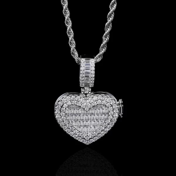 In White Gold, the Custom Iced Flip Cover Heart Pendant is a stunning combination of elegance and sentiment. Measuring 31mm, this pendant sparkles with VVS simulated diamonds and features a unique flip cover design that reveals a hidden photo or message. The White Gold plating offers a sleek and refined look, making it suitable for both casual wear and formal events. Hypoallergenic, scratch-resistant, and waterproof, this pendant ensures that your style stays flawless while keeping your most cherished memories close.