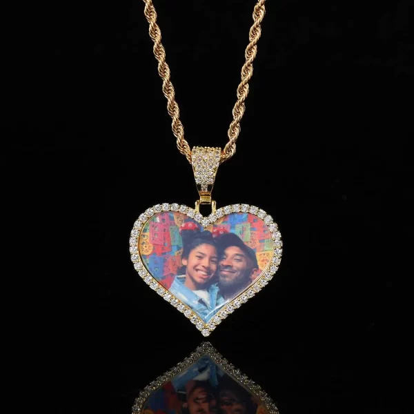 The Yellow Gold Custom Heart Picture Pendant offers a sentimental touch to your Hip Hop jewelry collection. Featuring a 39mm heart-shaped pendant framed in Yellow Gold-plated metal, this piece allows you to display your personal photos surrounded by VVS simulated diamonds. Hypoallergenic, scratch-resistant, and waterproof, this pendant is perfect for daily wear or special occasions. Whether gifting or keeping it as a cherished memory, the Yellow Gold finish adds warmth and elegance to this unique, personal accessory.