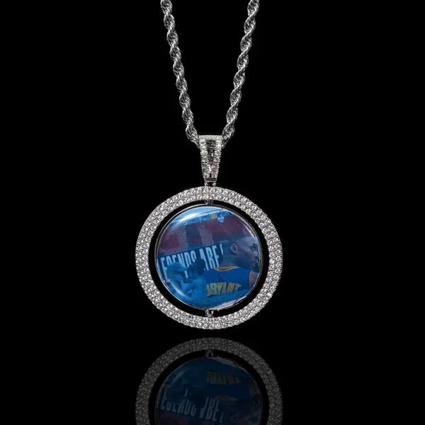 The White Gold Custom 3D Spinner Pendant offers a unique way to display two pictures. Crafted from white gold with a spinning design, this hypoallergenic, waterproof pendant is perfect for adding personal flair to your Hip Hop style.