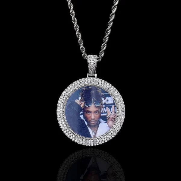 The Custom 2-Layer Diamond Picture Pendant in White Gold offers a modern take on memory preservation. Surrounded by shimmering stones, the 40mm pendant allows you to showcase your personal photo in style. Hypoallergenic and waterproof, it’s perfect for everyday wear or as a meaningful gift, adding elegance to any look with a Hip Hop edge.