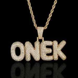 Take your Hip Hop style to the next level with the Custom Bubble Letter Pendant in Yellow Gold. This oversized pendant, framed in luxurious gold plating and adorned with VVS simulated diamonds, delivers bold and eye-catching bling. Hypoallergenic and waterproof, it's designed for comfort and style, whether you're wearing it to a party or making a statement at a casual event. Customize this piece with your initials or a favorite word to add a unique and personal touch that’s as stylish as it is meaningful.