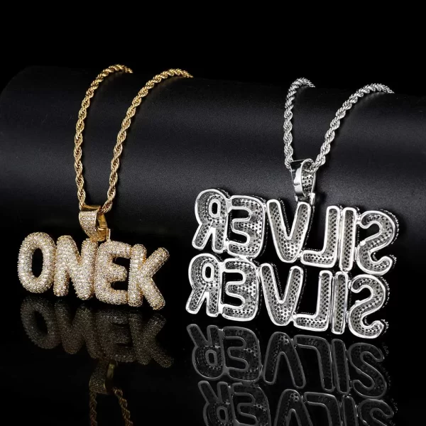 The Custom Bubble Letter Pendant in White Gold combines bold style with personal flair. Crafted in white gold plating and encrusted with VVS simulated diamonds, this oversized pendant is hypoallergenic and scratch-resistant, perfect for everyday wear or special occasions. Add your initials or favorite word to make this pendant uniquely yours, blending Hip Hop aesthetics with personal style for a standout look that’s both luxurious and meaningful.