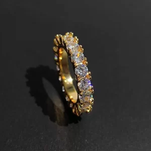 The 1 Layer Iced Prong Ring in Yellow Gold brings a sophisticated touch to your jewelry collection. With VVS Simulated Diamonds carefully set in a Yellow Gold band, this piece offers a sleek, luxurious look. The prong setting ensures each stone sparkles with maximum brilliance, making it the perfect accessory for everyday wear or special occasions. Ideal for anyone looking to elevate their Hip Hop style with elegance.