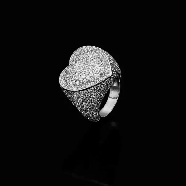 The Iced Bling Heart Ring in White Gold brings elegance and romance to your jewelry collection. Featuring a heart-shaped design with VVS Simulated Diamonds, this White Gold ring adds a luxurious touch to any look. Perfect for Hip Hop fans who want to show off their style with a romantic twist.