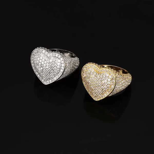 The Iced Bling Heart Ring in White Gold brings elegance and romance to your jewelry collection. Featuring a heart-shaped design with VVS Simulated Diamonds, this White Gold ring adds a luxurious touch to any look. Perfect for Hip Hop fans who want to show off their style with a romantic twist.