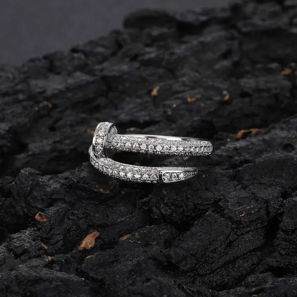 The Iced Nail Open Ring in White Gold delivers a creative, edgy take on traditional ring designs. Featuring VVS Simulated Diamonds set in a nail-shaped open design, this White Gold ring combines elegance and modern flair. Ideal for Hip Hop fans looking to make a statement with their accessories, this ring adds a unique touch of sophistication to any look.