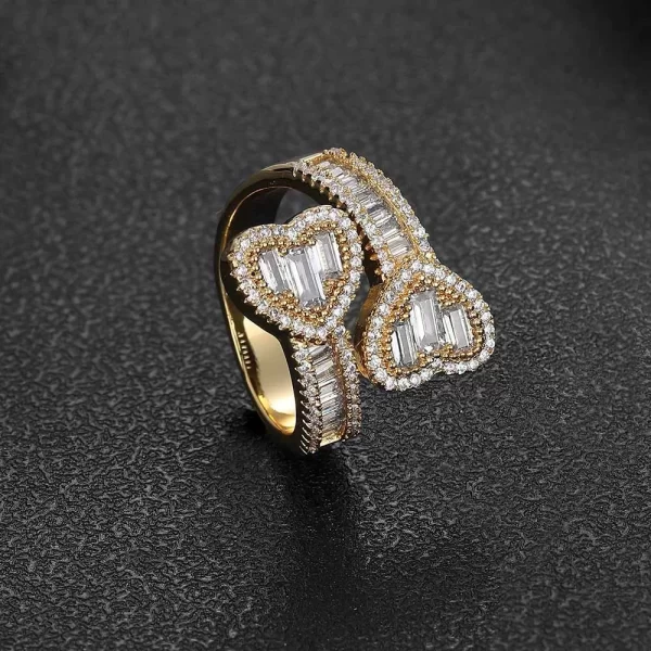 The Iced Heart Open Ring adds a romantic touch to your style. This open ring design features VVS Simulated Diamonds set in a Yellow Gold band, with a heart-shaped motif that exudes elegance. Whether you're dressing for a date or just want to add some love to your outfit, this ring is the perfect accessory.