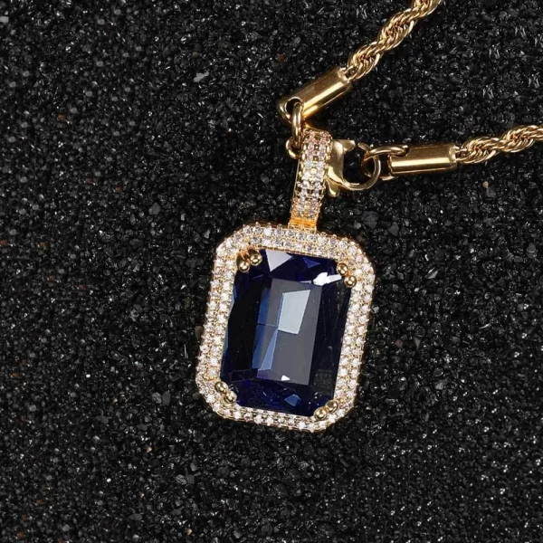 The Yellow Gold Indigo Sapphire Stone Pendant adds a bold and luxurious touch to your jewelry collection. Featuring a rich, deep blue sapphire framed by VVS simulated diamonds, this pendant is set in a Yellow Gold-plated frame, offering a warm contrast to the gemstone's cool hue. Hypoallergenic and designed for long-lasting wear, it’s perfect for both casual and formal outfits. The Yellow Gold finish paired with the vibrant blue sapphire creates a striking look, blending elegance and Hip Hop style seamlessly.