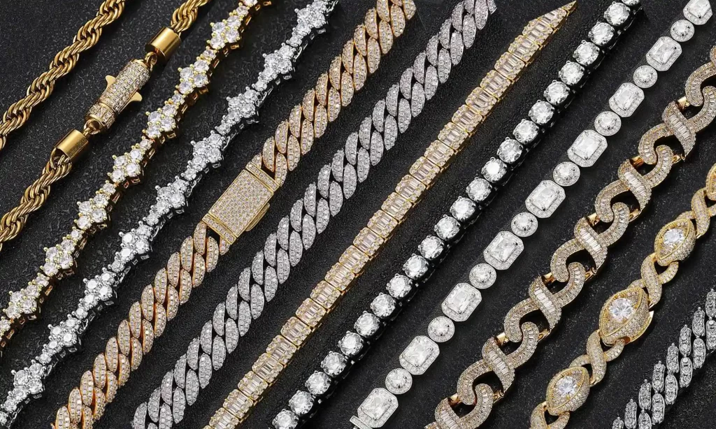 This image presents a stunning collection of hip hop jewelry, arranged against a dark backdrop. On the left, multiple rows of iced-out Cuban link bracelets, encrusted with diamonds and moissanites, glisten under the light. To the right, an assortment of gold and diamond rings, embodying various styles from classic to modern, are prominently displayed. Each piece captures the light differently, highlighting the meticulous craftsmanship and rich detail that make these items not just accessories, but symbols of the hip hop culture.