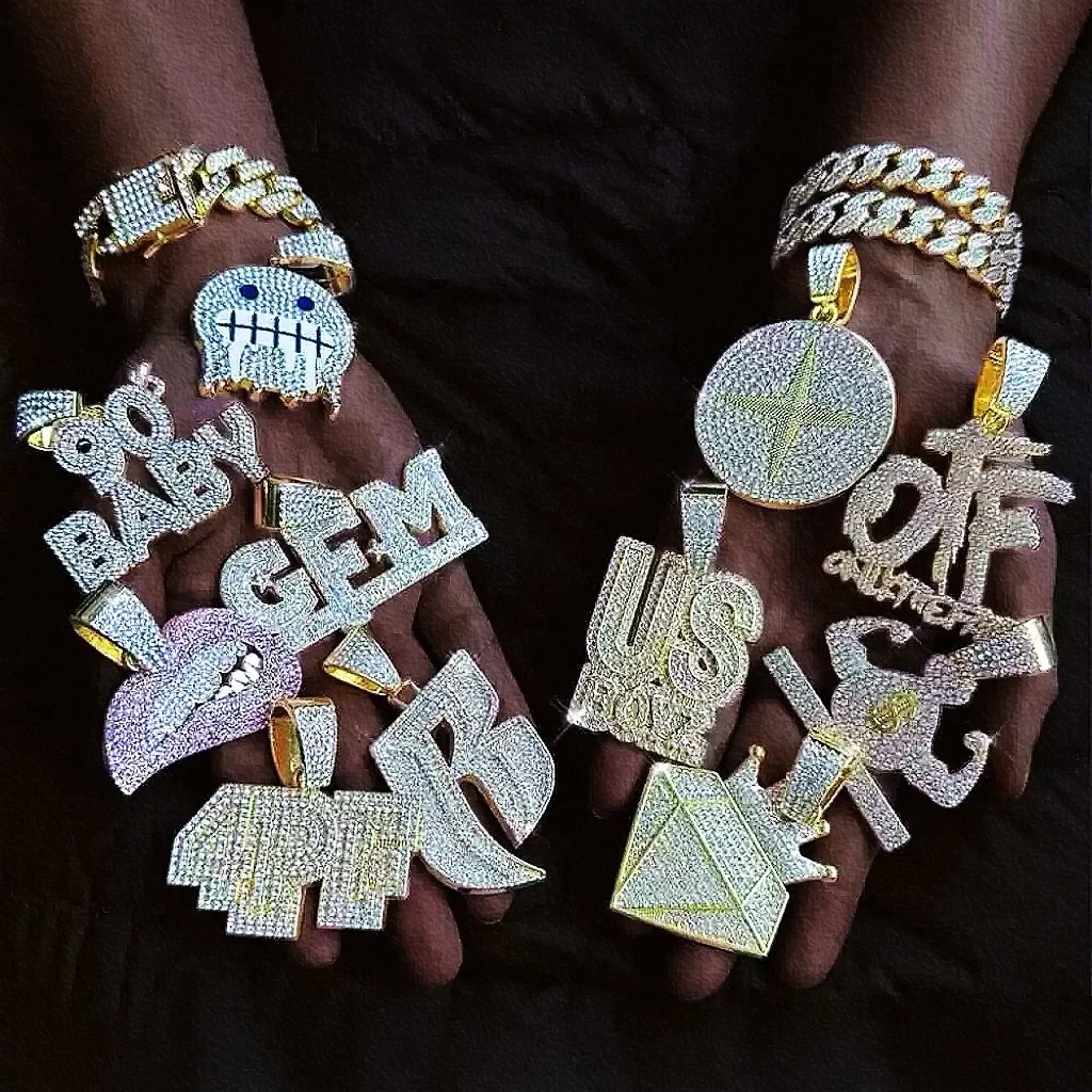 This vibrant photo captures a stylish individual holding a wide assortment of hip-hop pendants, each one shining with intense "bling bling" energy. From classic crosses to bold dollar signs and unique custom pieces, the variety of designs brings out the creativity and diversity of hip-hop jewelry. Each pendant catches the light brilliantly, embodying luxury, individuality, and street style. This dazzling collection of pendants represents personal expression and boldness, making it a true showcase of hip-hop culture's finest.